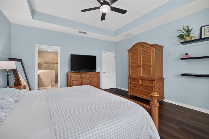 Primary bedroom with armoire and ceiling fan at 538 Porta Rosa Circle, St. Augustine, FL 32092