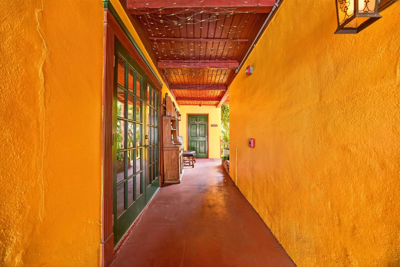 Interior corridor with wood beam ceiling and yellow walls at 115 Cordova St, St. Augustine, FL