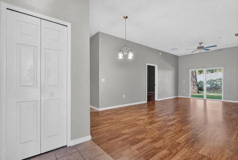 Living room with vaulted ceiling and ceiling fan at 8196 Cabin Lake Cir, Jacksonville, FL 32256