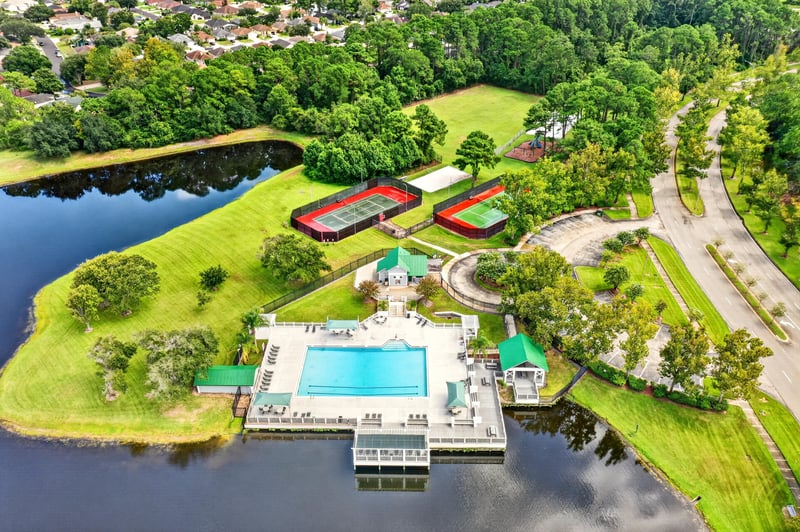 Aerial view of community pool and courts along the water in Jacksonville, FL