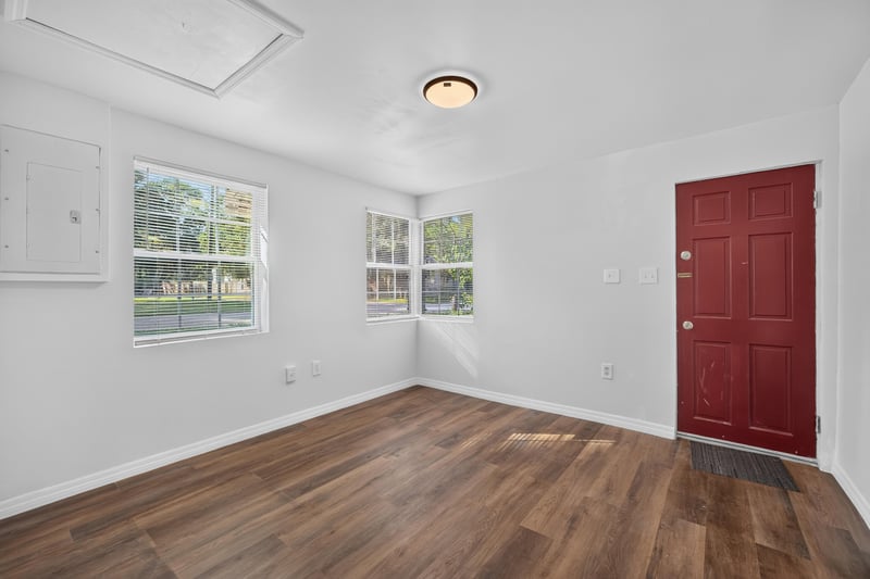 Living room corner with red front door at 4951 Halls Dr