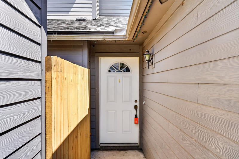 Side entry door with wood fence at 4427 Millstone Ct, Jacksonville, FL