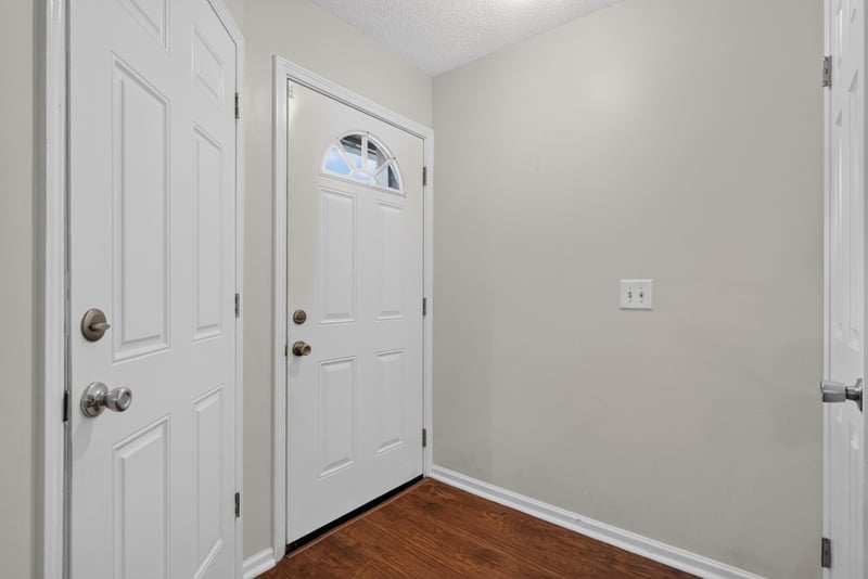 Entry foyer with wood floors and front door at 4427 Millstone Ct, Jacksonville, FL