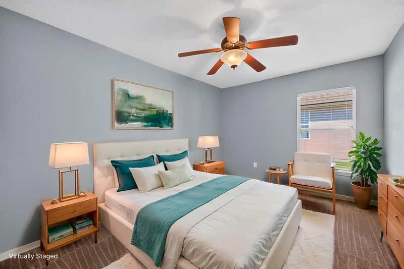Virtually staged bedroom with blue walls at 2282 Justin Lake Dr, Jacksonville, FL