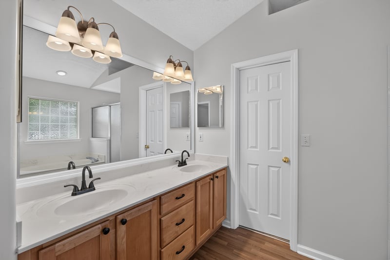 Bathroom with double-sink vanity and wood cabinets at 2480 Ridge Will Dr, Jacksonville, FL 32246