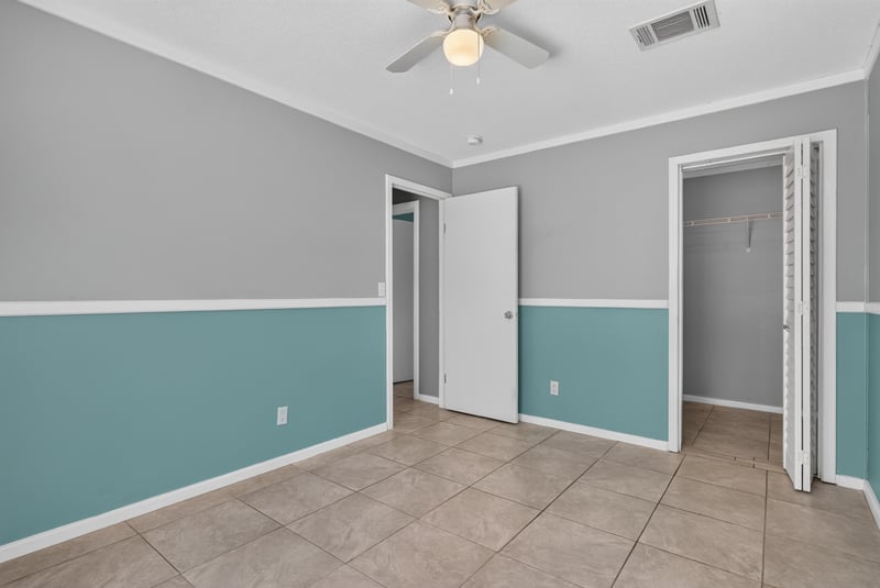 Bedroom hallway view with blue and teal walls at 2549 Snapdragon Ave, Middleburg, FL 32068