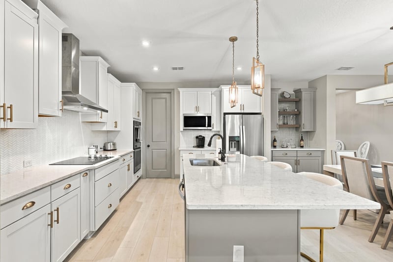 Kitchen island and cabinetry with wood flooring at 3921 Spyglass Hill Ln