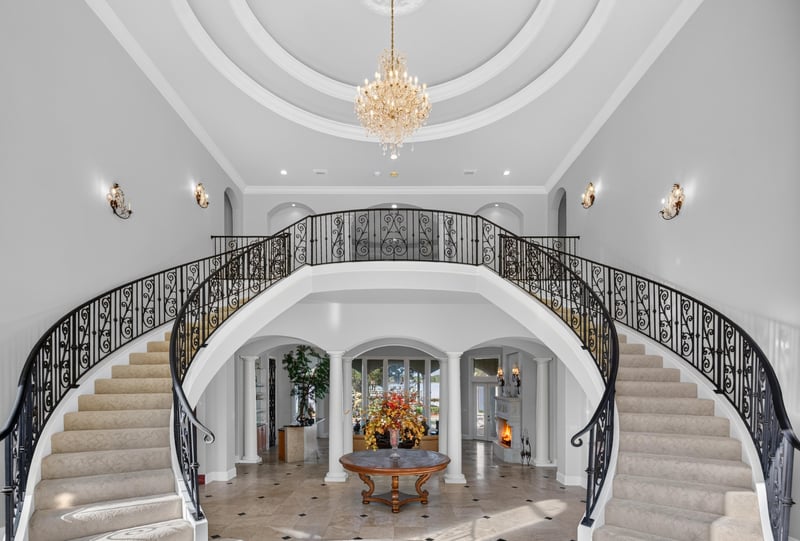 Foyer view of the dual staircases and round entry table at 344 Broward Rd, Jacksonville, FL