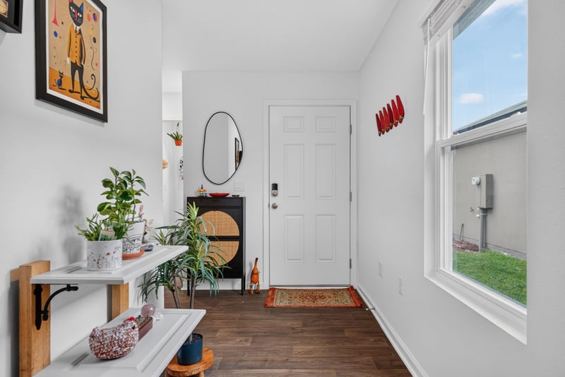 Front entry with door and wall art at 4276 Quaking St, Jacksonville, FL 32218