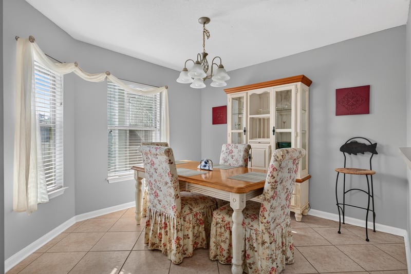 Dining area with table, chairs and china cabinet at 206 16th St, St. Augustine, FL 32080