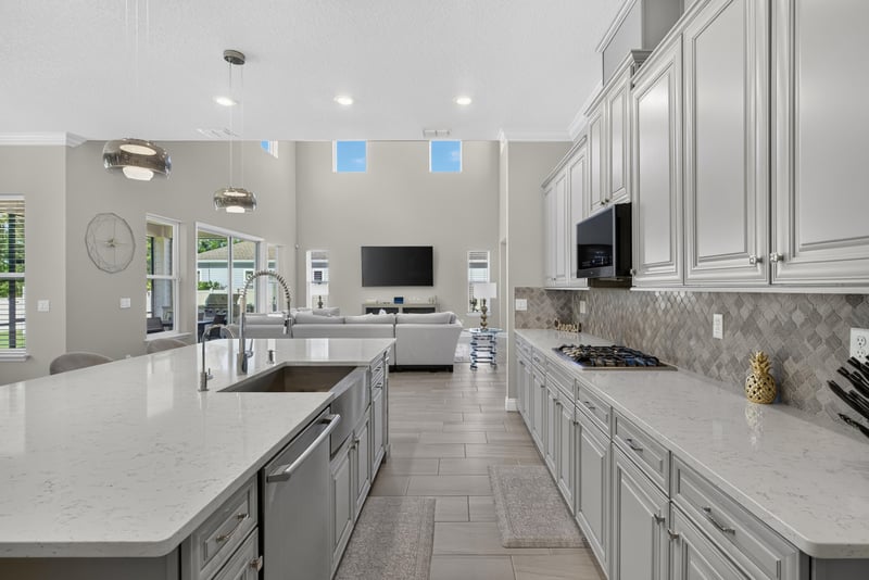 Kitchen with white cabinetry and skylight at 22 Azura Point