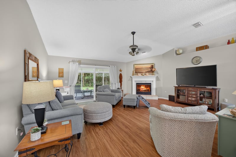 Living room with fireplace, open to kitchen at 13514 Las Brisas Way N, Jacksonville, FL