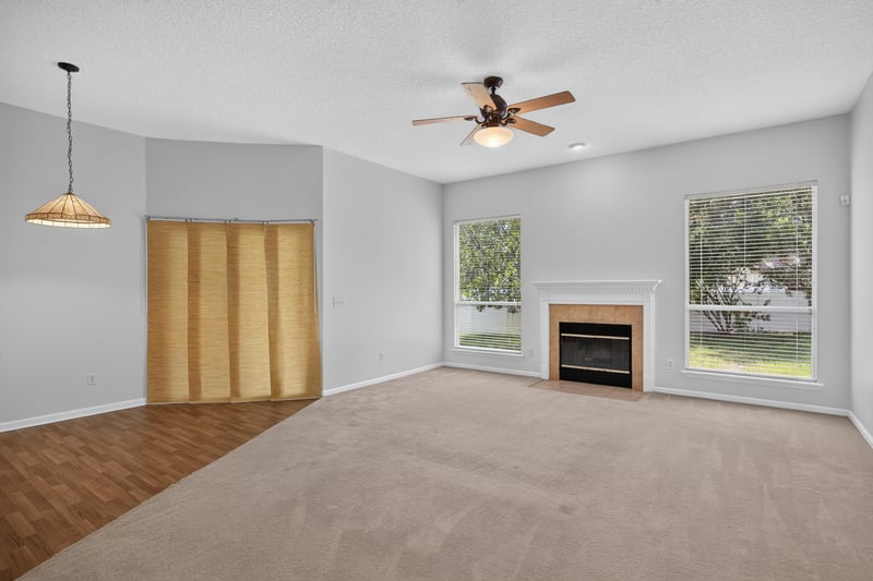 Living room with fireplace and curtained windows at 2480 Ridge Will Dr, Jacksonville, FL 32246