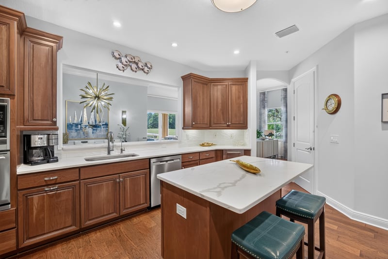 Kitchen island with pendant lighting and bar stools at 140 Ave De La Mer, Palm Coast, FL 32137