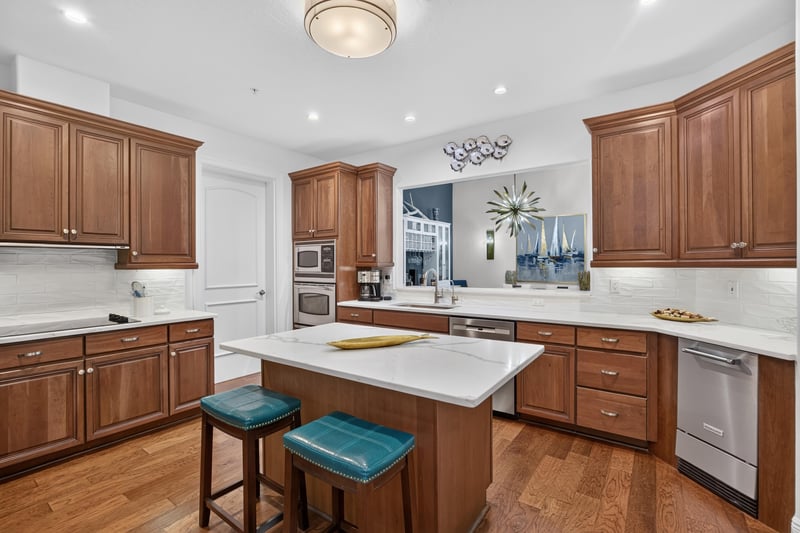 Kitchen with wood cabinets and quartz island seating at 140 Ave De La Mer, Palm Coast, FL 32137