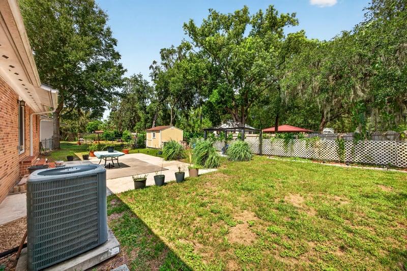 Backyard open lawn with AC unit at 1847 Grove Park Dr, Orange Park, FL