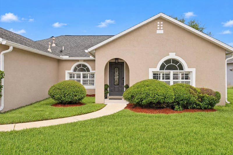Front entry with arched window and covered walkway at 11197 Illford Dr