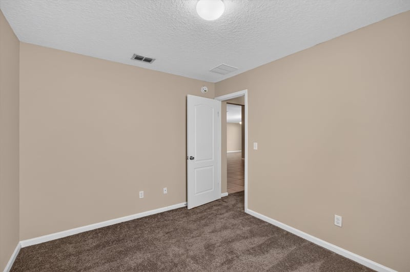 Carpeted bedroom with doorway view at 469 Glendale Ln, Orange Park, FL