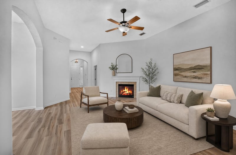 Living room virtually staged with sofa and fireplace at 3101 E Banister Rd, St. Augustine, FL 32092