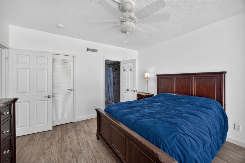 Bedroom with wood dresser and closet doors at 601 1st St S, Jacksonville Beach