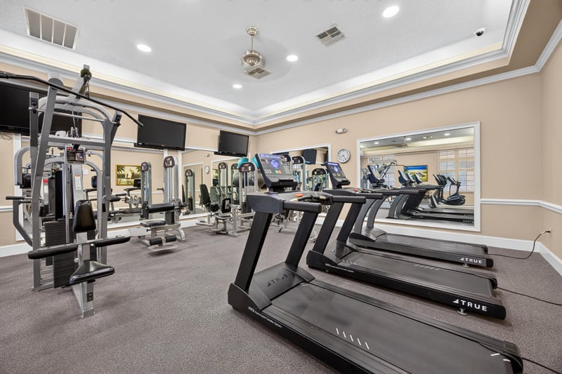 Community fitness center with cardio equipment in River Glen