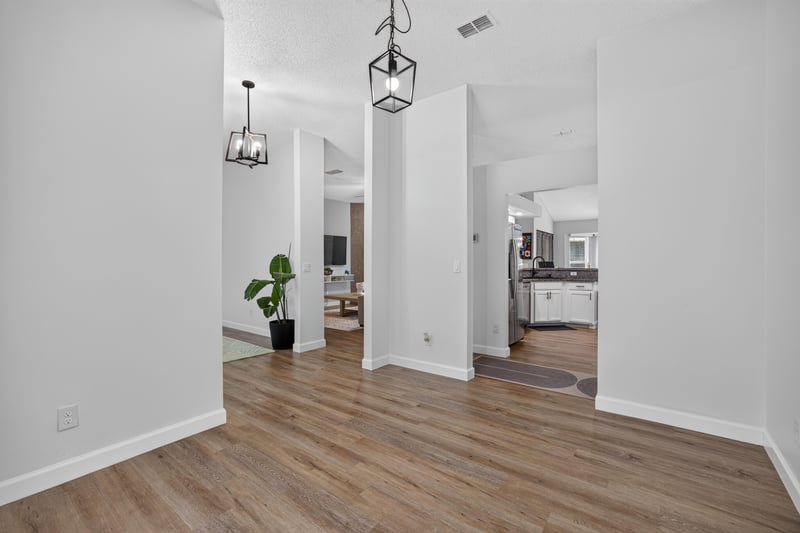 Hallway view toward kitchen and dining area at 8921 Needlepoint Pl, Jacksonville, FL 32244
