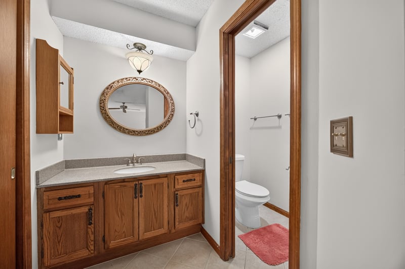 Bathroom with oak vanity and mirror at 2460 San Sago Ln, Jacksonville, FL