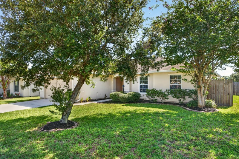 Front yard with mature tree at 7545 Lirope St, Jacksonville, FL 32244