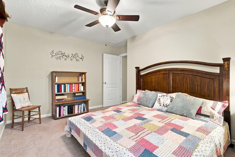 Secondary bedroom with window and bookshelf at 10923 Black Diamond Ct, Jacksonville, FL