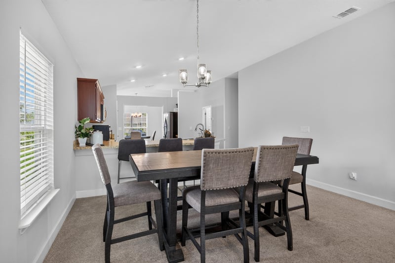 Dining area with wood table and bench seating at 9846 Olivia St, Jacksonville, FL