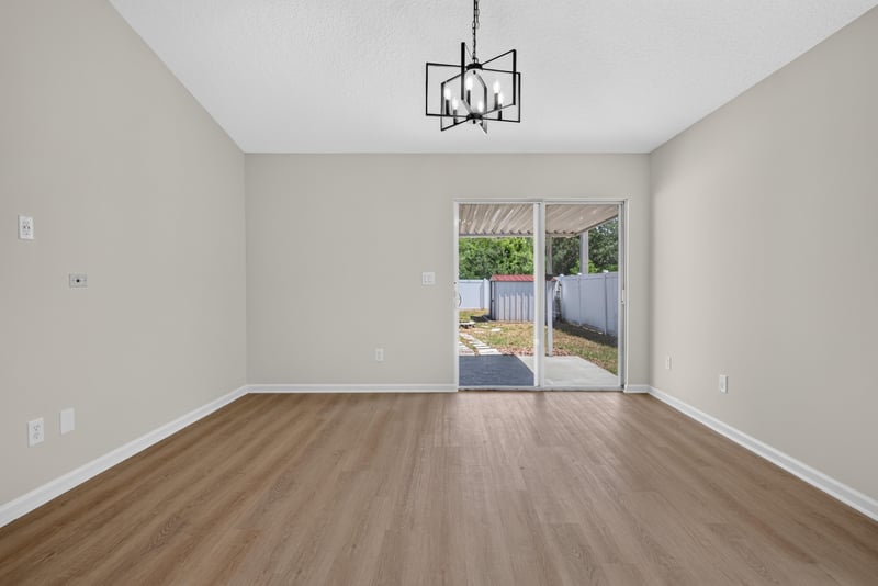 Living room with sliding glass door to patio at 224 Pine Arbor Cir, St. Augustine, FL 32084