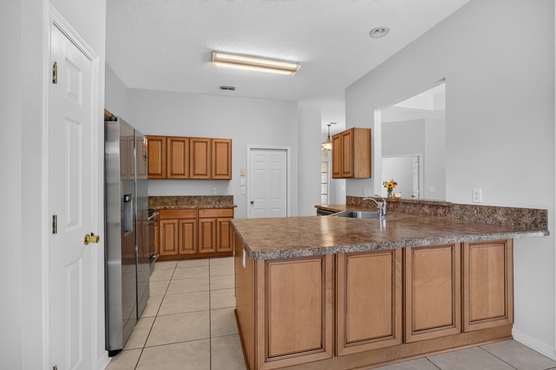 Kitchen view with stainless refrigerator and pendant light at 456 Bay Point Way N, Jacksonville, FL 32259