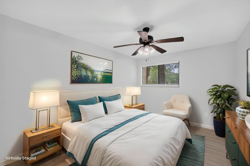 Bedroom with bed and chair, virtually staged, at 3801 Crown Point Rd unit 2061, Jacksonville, FL 32257