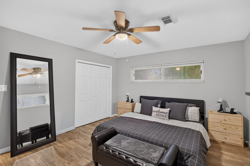 Bedroom with dresser and full-length mirror at 9506 Harriet Ave, Jacksonville, FL 32208