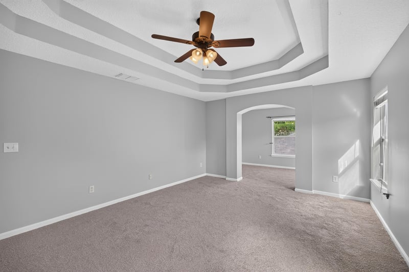 Bonus room with tray ceiling and arched doorway at 470 Sparrow Branch Cir, Jacksonville, FL 32259