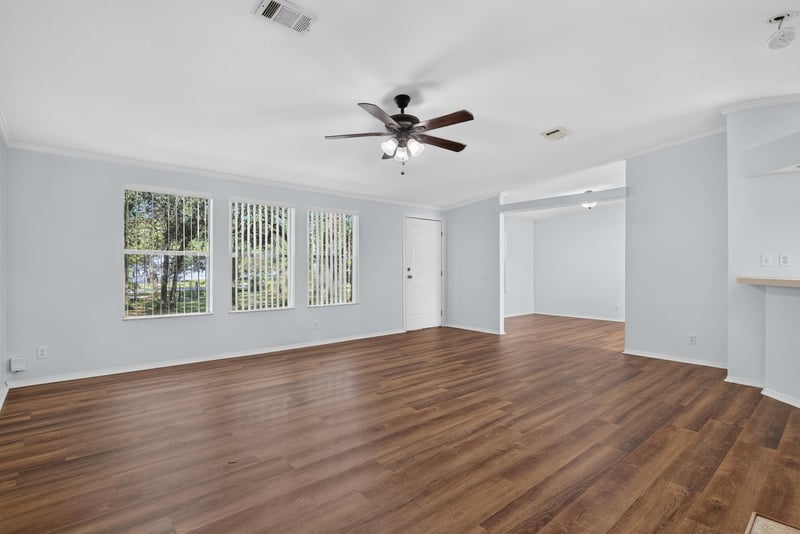 Open living area with windows and wood flooring at 3215 Robin Ln, Middleburg, FL
