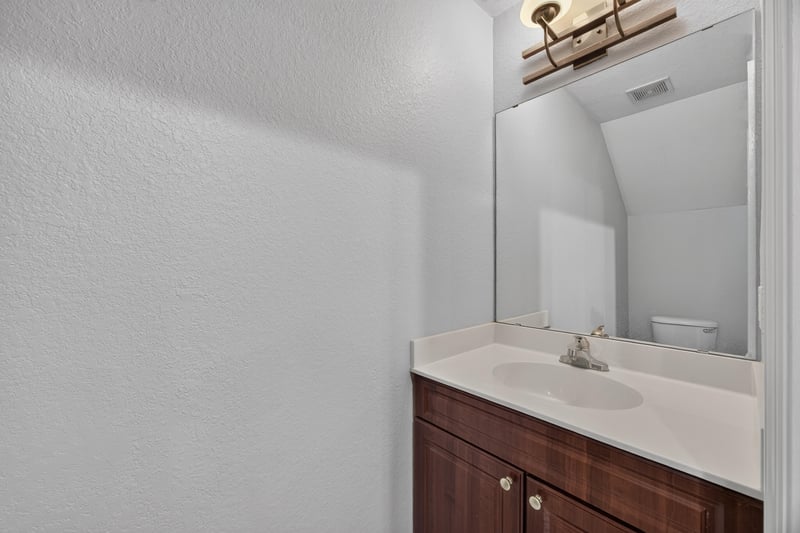 Bathroom vanity with mirror and white counter at 9745 Touchton Rd, Jacksonville, FL 32246
