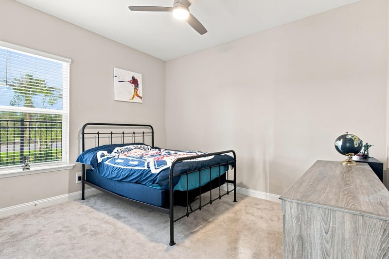 Bedroom with metal bed frame and carpet flooring at 27 Holly Rdg Wy, St. Augustine, FL