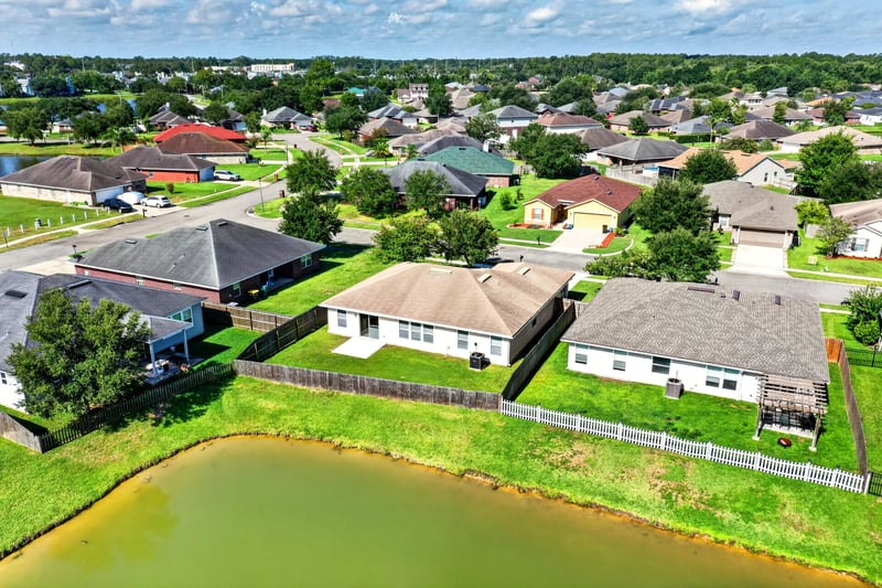 Aerial view of the home and neighborhood pond at 7545 Lirope St, Jacksonville, FL 32244