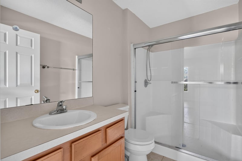 Bathroom with vanity and glass shower door at 7047 Deer Lodge Cir, Jacksonville