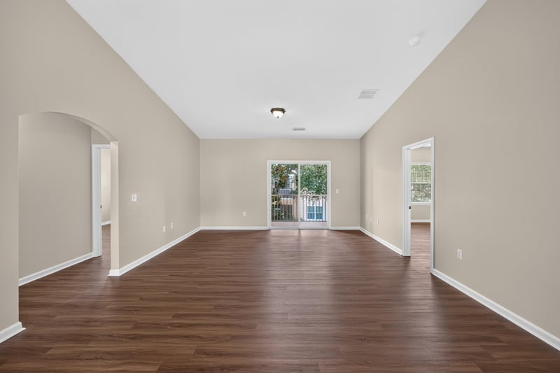 Living room with vaulted ceiling and sliding glass door at 3750 Silver Bluff Blvd, Orange Park, FL