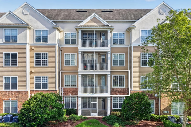 Exterior view of the condo building and parking at 11251 Campfield Dr unit 1202, Jacksonville, FL 32256