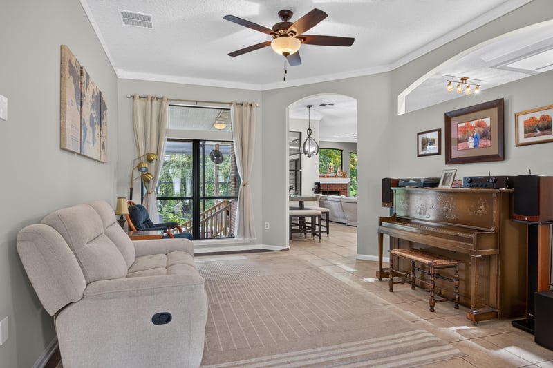 Living room with piano and tile floor at 2125 Blue Heron Cove Dr, Orange Park, FL 32003
