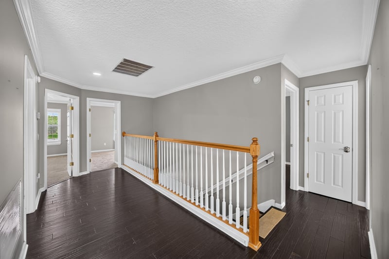 Staircase with wood railing at 1493 Greyfield Dr, St. Augustine, FL 32092