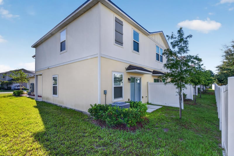 Side exterior view with yard and siding at 4024 Bay Hawk Ct, Jacksonville, FL