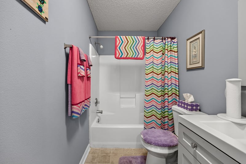 Bathroom with patterned shower curtain at 5375 Dodge Rd, Jacksonville, FL 32209