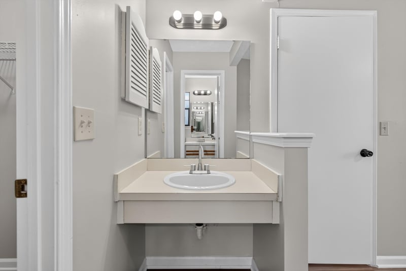 Bathroom vanity and mirror at 8010 International Village Dr, Jacksonville, FL 32277