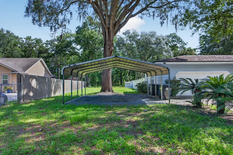 Backyard with carport and mature tree at 892 Branscomb Rd, Green Cove Springs, FL