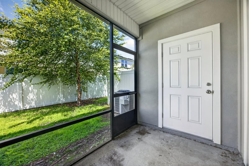 Screened porch with door to backyard at 2837 Black Buck Cir, Jacksonville, FL 32225