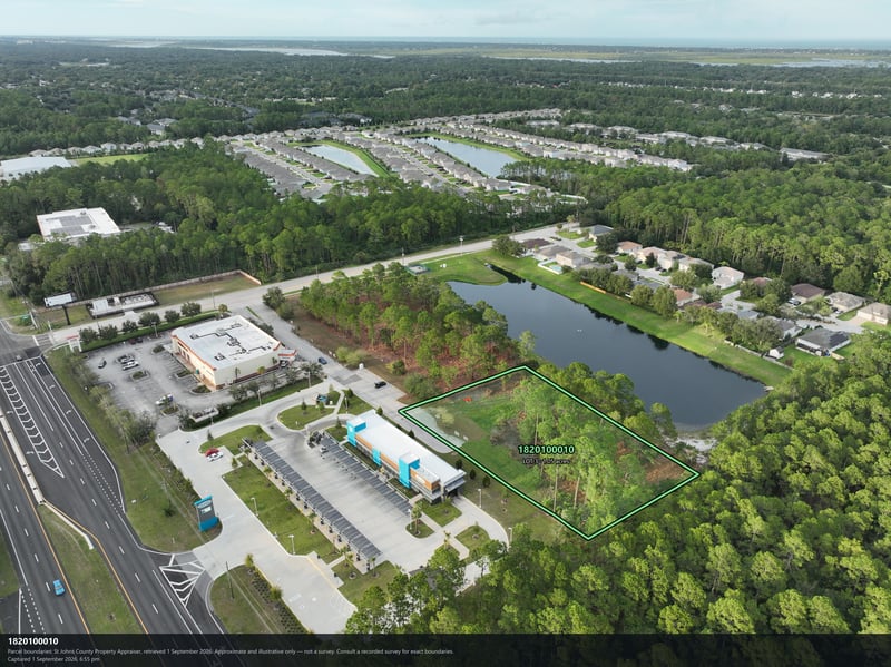 Aerial view of the pond and tree-lined parcel beside the road at 4900 US-1, St. Augustine, FL 32086